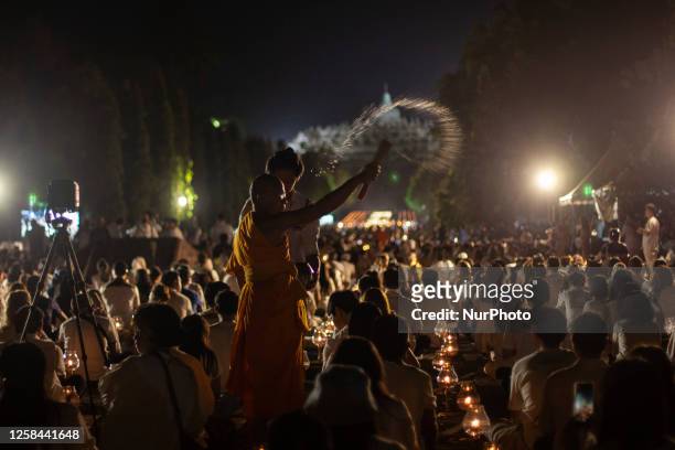 Buddhist devootes and tourist took a prayer before they release lanterns into the air during Vesak Day celebration at Borobudur temple, Central Java,...