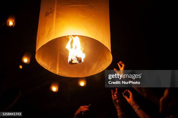 Buddhist devootes and tourist release lanterns into the air as a symbol of enlightening and peace during Vesak Day celebration at Borobudur temple,...