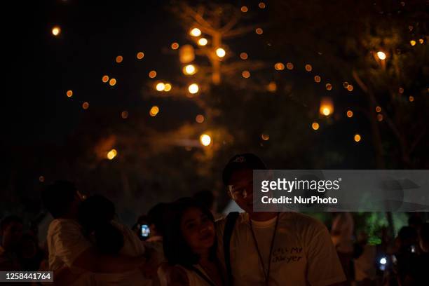 Buddhist devootes and tourist release lanterns into the air as a symbol of enlightening and peace during Vesak Day celebration at Borobudur temple,...
