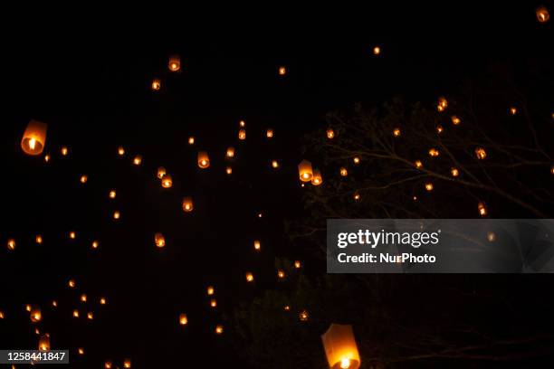 Buddhist devootes and tourist release lanterns into the air as a symbol of enlightening and peace during Vesak Day celebration at Borobudur temple,...