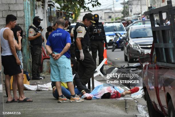 Graphic content / A police expert examines the body of a person killed during a shooting in Guayaquil, Ecuador, on June 4, 2023. Gunmen killed at...
