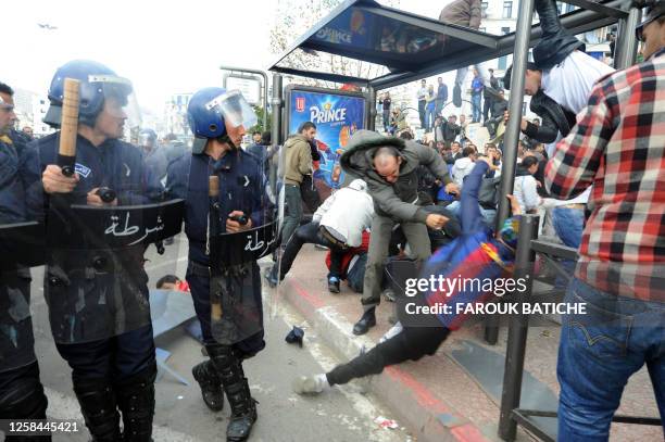 Demonstrators clash with a plainclothed police during a protest on February 12, 2011 in Algiers. Up to 2,000 Algerian demonstrators briefly forced a...