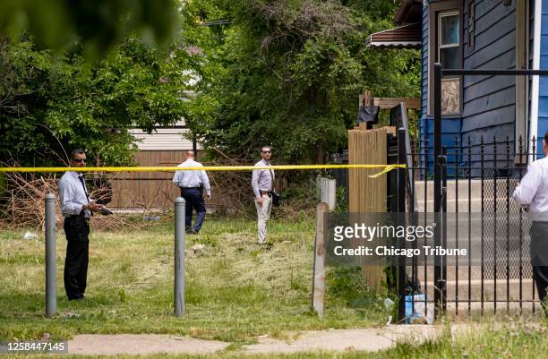 Chicago police detectives canvass the scene in the 4800 block of West Iowa Street in Chicago&apos;s Austin neighborhood after an early morning...