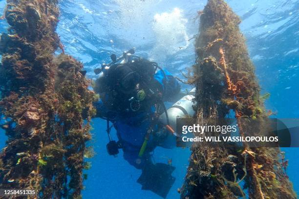 Diver retrieves a ghost net, spotted by members of the NGO Aegean Rebreath, from the seabed at a depth of 45 metres, off the coast of the island of...