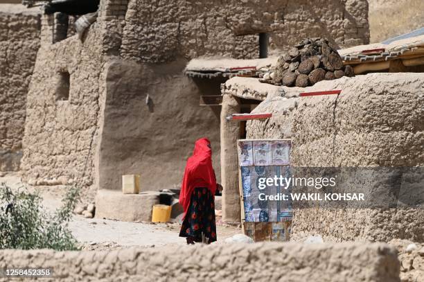 In this photo taken on June 4 a woman stands outside her house at Kandali village in Sholgara district of Balkh Province.