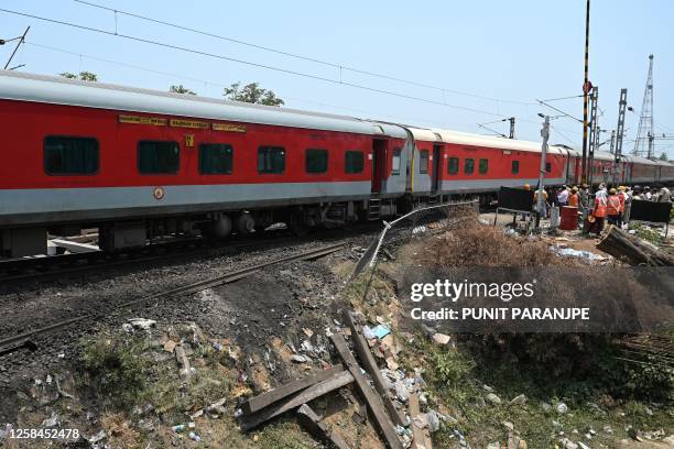 Long-distance passenger train runs on the newly restored tracks at the accident site of a recent three-train collision near Balasore, about 200 km...