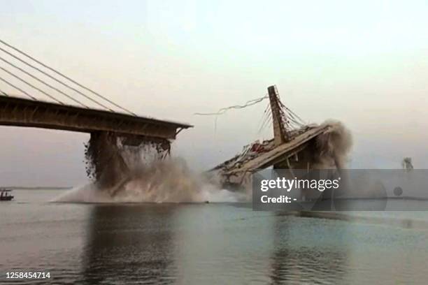 This photo taken on June 4 shows an under construction bridge collapsing into the river Ganges in Bhagalpur district in India's eastern state of...