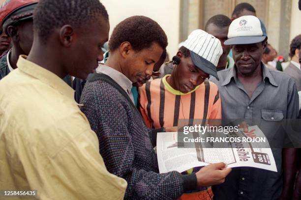 Senegalese people read the elections results in the newspaper Sud, as Opposition leader and former candidate for the presidential elections,...