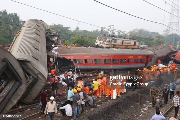 June 03 Balasore, India: Rescue workers recover victims' bodies from a carriage wreckage of a three-train collision near Balasore, At least 280...