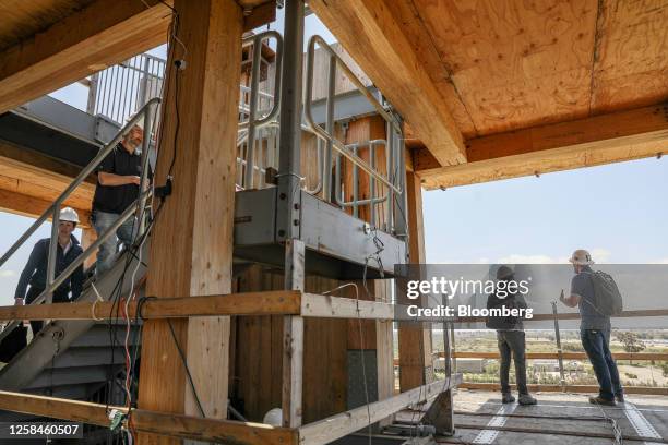 Engineers examine a building following an earthquake simulation during a shake-table trial in San Diego, California, US, on Tuesday, May 9, 2023. The...
