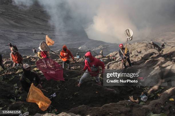 Tenggerese walk and hike carrying agricultural products and livestock to be sacrificed during the Yadnya Kasada Festival at the crater of Mount Bromo...