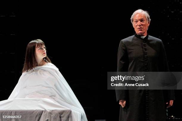 Father Merrin played by Richard Chamberlain talks of demons as Regan MacNeil played by Emily Yetter listens for a review of "The Exorsist" at the...