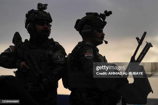 Members of the Iraqi security forces protect the police club stadium in Baghdad on June 5 during the annual sports festival of the Iraqi Ministry of...