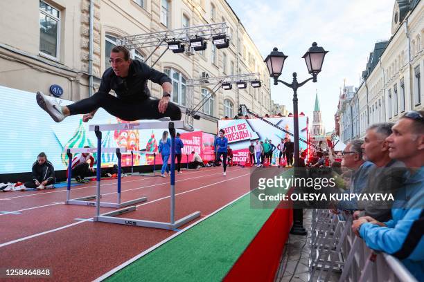 Russian hurdler Sergey Shubenkov takes a warm-up run for the 60m hurdles event of the Athletics Week local track and field tournament at the central...