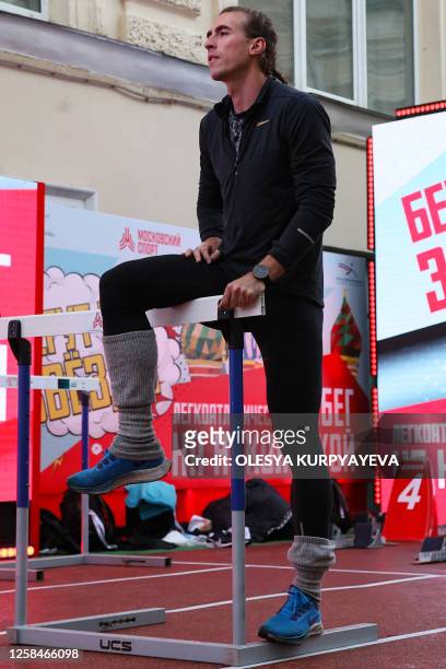 Russian hurdler Sergey Shubenkov warms up for the 60m hurdles event of the Athletics Week local track and field tournament at the central Nikolskaya...