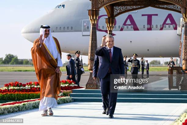 President of Uzbekistan Shavkat Mirziyoyev welcomes the Emir of Qatar Sheikh Tamim ibn Hamad Al Thani at Samarkand International Airport in Tashkent,...