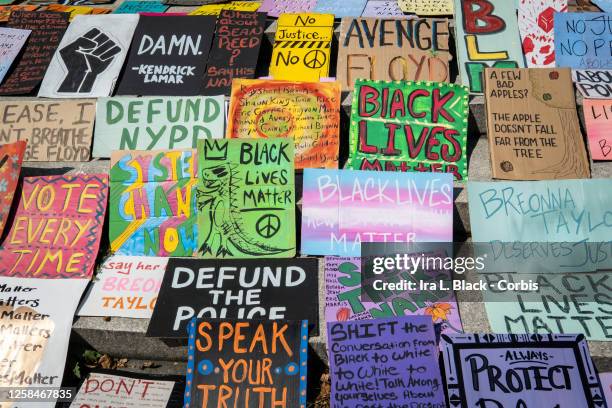 July 25: Hand painted and crafted signs lay on the ground at Cadman Plaza, Brooklyn New York waiting for protesters to claim one that speaks to them....