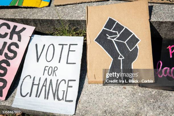 July 25: Hand painted and crafted signs which include one that has a back power fist and another that says, "Vote for Change" lay on the ground at...