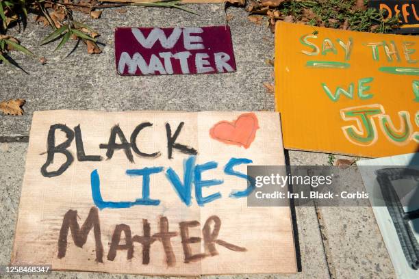 July 25: Hand painted and crafted signs which include one that says, "Black Lives Matter" with a heart and another that says, "We Matter" lay on the...