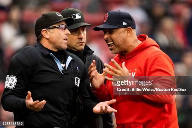 Manager Alex Cora of the Boston Red Sox argues with home plate umpire Chris Guccione after being ejected from the game at the end of the eighth...
