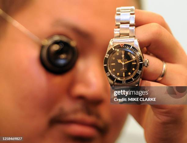 Lifestyle-luxury-HongKong-watches,FEATURE by Adrian Addison This photo taken on January 21, 2011 shows watch expert Genki Sakamoto showing a 1958...