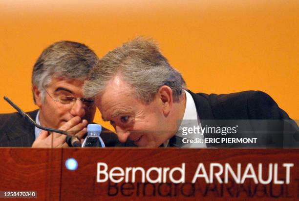 French luxury goods group LVMH CEO Bernard Arnault speaks with his company general director Antonio Belloni during a press conference to announce the...