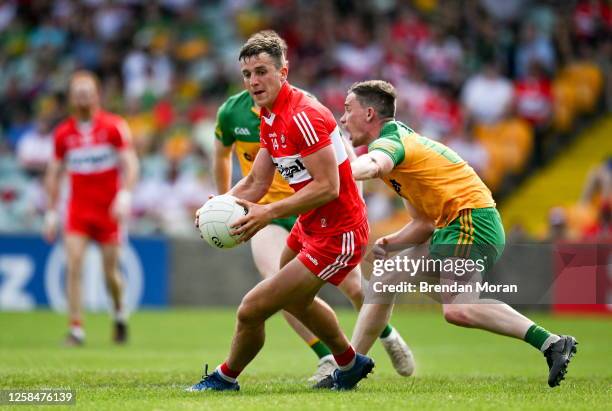 Donegal , Ireland - 4 June 2023; Shane McGuigan of Derry in action against Ciaran Thompson of Donegal during the GAA Football All-Ireland Senior...