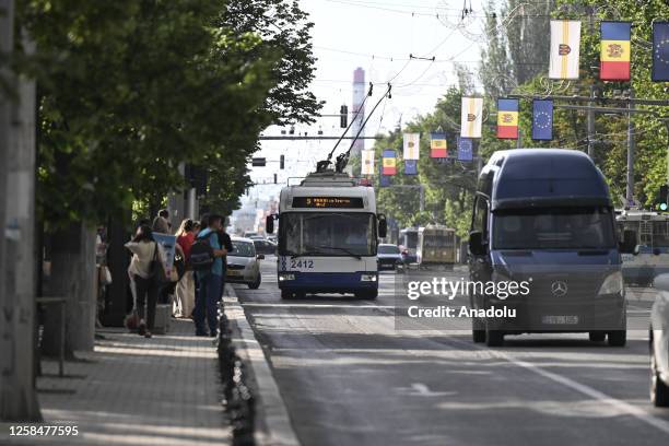 Vehicles drive through a road as passengers wait for public transport in Chisinau, Moldova on May 31, 2023. As a city rich in cultural influences and...