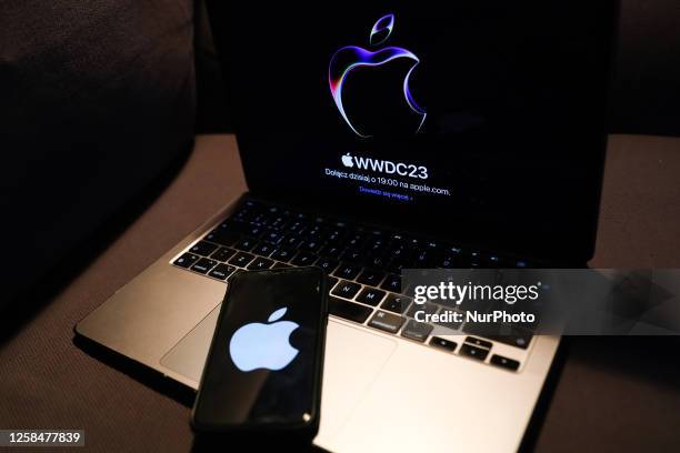 Laptop with Apple website displayed on a screen and Apple logo displayed on a phone screen are seen in this illustration photo taken in Krakow,...