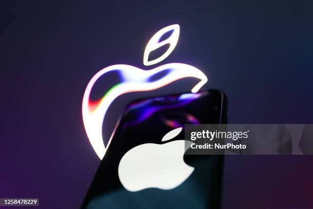 Apple website displayed on a laptop screen and Apple logo displayed on a phone screen are seen in this illustration photo taken in Krakow, Poland on...