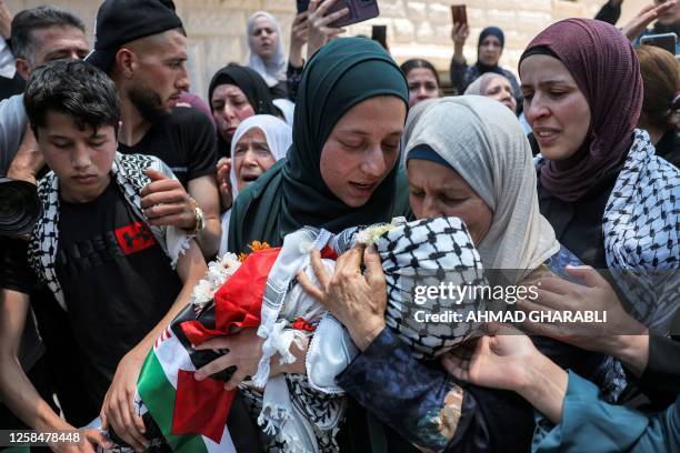 Graphic content / TOPSHOT - The mother of Mohammed Haitham al-Tamimi, a three-year-old Palestinian boy shot by Israeli forces in the occupied West...