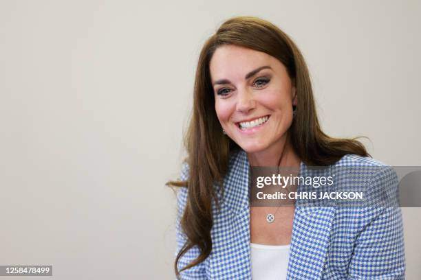 Britain's Catherine, Princess of Wales meets members of a group accessing the early years services during a visit to the Windsor Family Hub in...