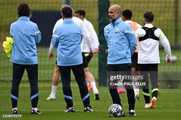 Manchester City's Spanish manager Pep Guardiola takes part in a team training session at Manchester City training ground in Manchester, north-west...