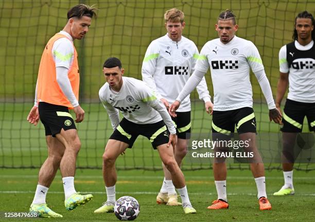 Manchester City's English midfielder Jack Grealish, Manchester City's English midfielder Phil Foden, Manchester City's Belgian midfielder Kevin De...