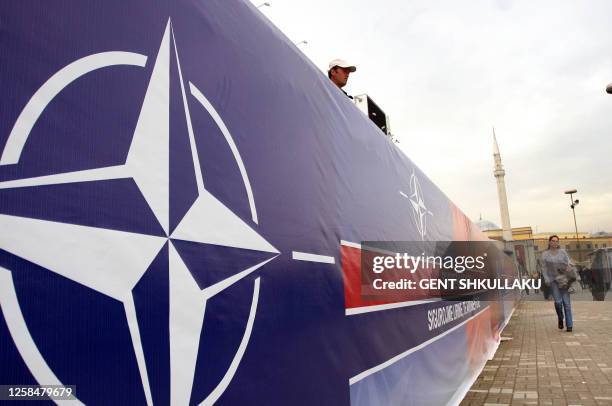 People walk by banners bearing Albanian and NATO insignia in the centre of Tirana on March 31, 2009. Albania and Croatia are expected to become...