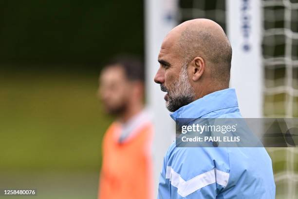 Manchester City's Spanish manager Pep Guardiola reacts as he takes part in a team training session at Manchester City training ground in Manchester,...