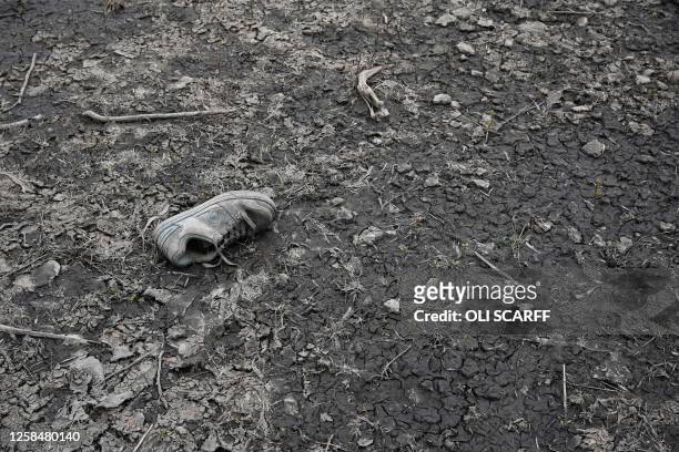 Discarded trainer is pictured on the drying bed of Woodhead Reservoir, revealed by a falling water level after a prolonged period of dry weather,...