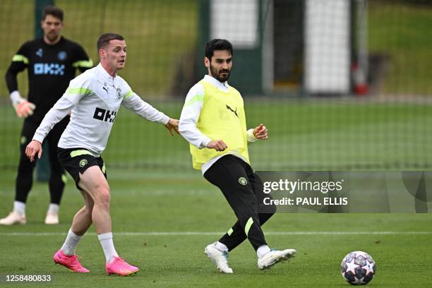 Manchester City's Spanish defender Sergio Gomez and Manchester City's German midfielder Ilkay Gundogan take part in a team training session at...