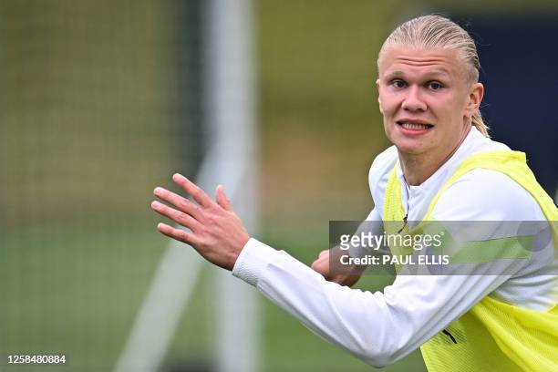 Manchester City's Norwegian striker Erling Haaland reacts as he takes part in a team training session at Manchester City training ground in...