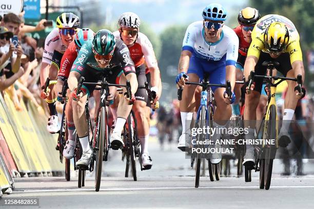 Yellow jersey of Overall Leader Jumbo-Visma's French rider Christophe Laporte sprints next to third placed Team Jayco AlUla's Dutch Dylan Groenewegen...