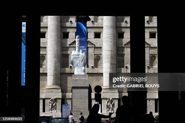 Sculpture by Italian artist Maurizio Cattelan, entitled "L.O.V.E" is pictured outside Palazzo Mezzanotte, Italy's stock exchange building, on June...
