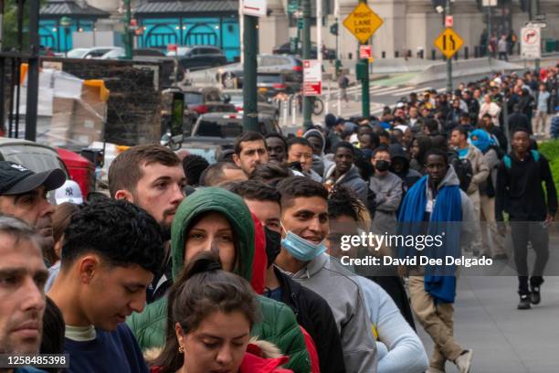 Hundreds of asylum seekers line up outside of the Jacob K. Javits Federal Building on June 6, 2023 in New York City. New York City has provided...