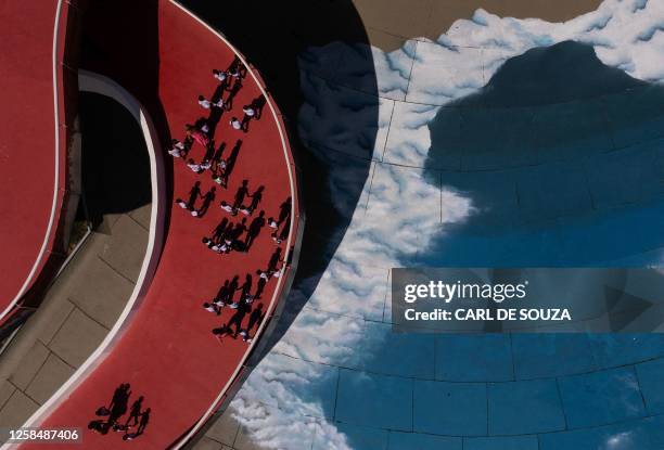 Aerial view of visitors passing by a design of clouds conceived by Brazilian graffiti artist Toz on the ground at the Museum of Contemporary Art in...