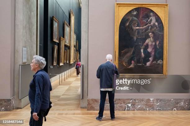 Visitor examines the work of art titled "The Annunciation" by Italian painter Girolamo Mazzola Bedoli, displayed during the the press preview of the...