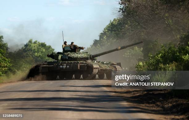 Ukrainian servicemen drive a tank on a road near the front line in the Donetsk region on June 5 amid the Russian invasion of Ukraine.