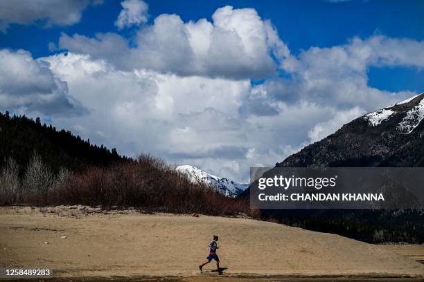 Ultramarathon runner Courtney Dauwalter runs through the mountains near Twin Lakes, Colorado, on May 16, 2023. Dauwalter sits at the apex of an elite...