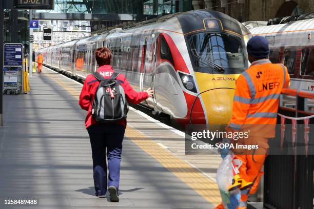 London North Eastern Railway train arrives at London King's Cross station.