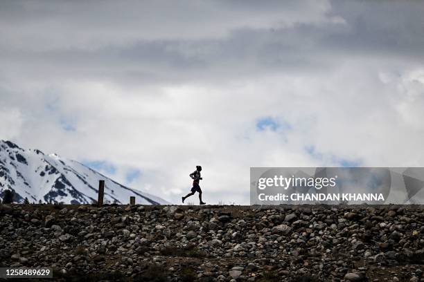 Ultramarathon runner Courtney Dauwalter runs over a dam near Twin Lakes, Colorado, on May 16, 2023. Dauwalter sits at the apex of an elite group of...