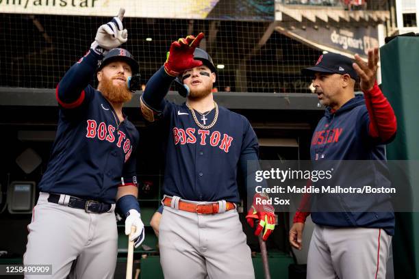 Justin Turner of the Boston Red Sox, Alex Verdugo of the Boston Red Sox, and Manager Alex Cora of the Boston Red Sox look on from the dugout before a...