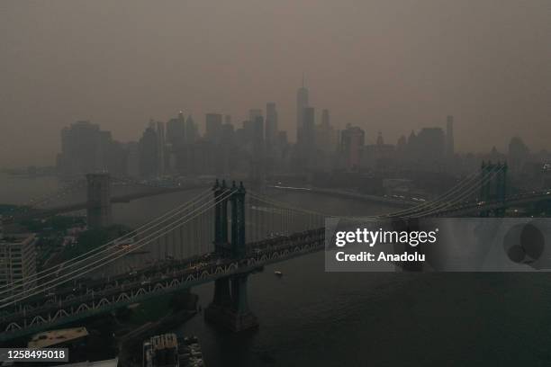 The Downtown Manhattan skyline stands shrouded in a reddish haze as a result of Canadian wildfires on June 06, 2023 in New York City. Over 100...